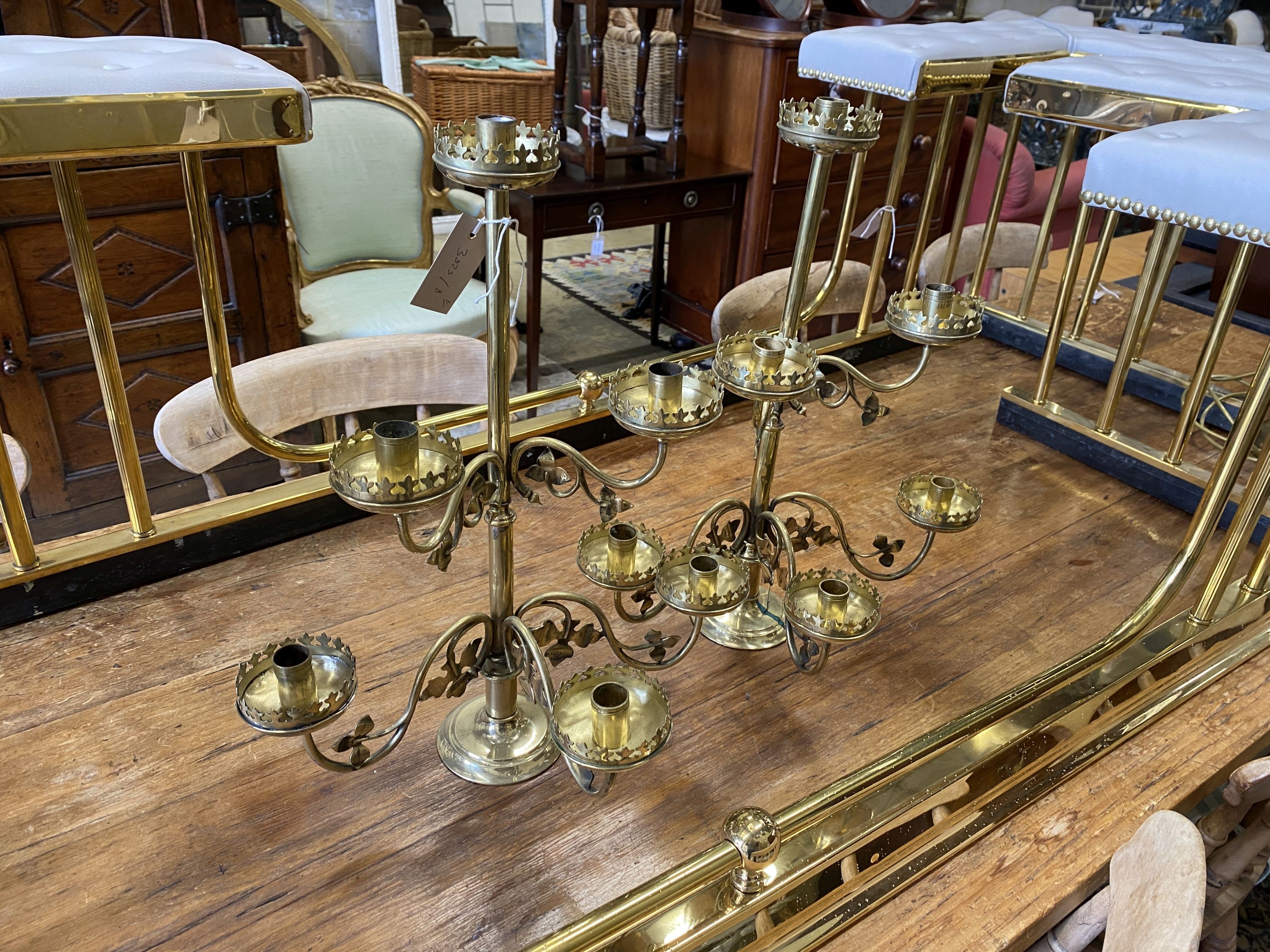 A pair of Victorian brass six branch candlesticks, height 52cm